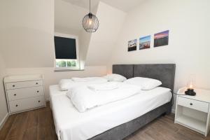 a bedroom with two white beds and a window at Casa del Rops, luxury apartment, two bathrooms and roof terrace, near the beach in Cadzand