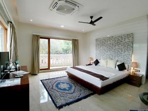 a bedroom with a large bed and a window at The Luxury Maharaja The Royal Resort in Thane