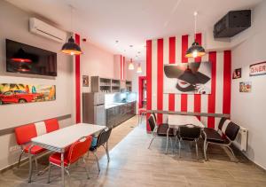 a dining room with red and white striped wall at Full Moon Budapest in Budapest