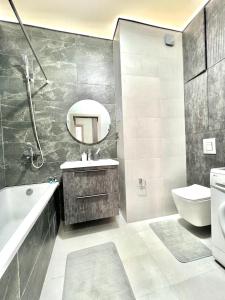 a bathroom with a sink toilet and a mirror at С новым ремонтом Expo new life 2 in Taldykolʼ