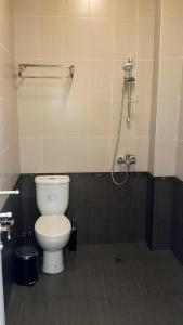 a bathroom with a toilet and a shower at Typebi in K'obulet'i +13 photos