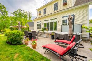 a patio with chairs and a grill in front of a house at In-Home Arcade Hot Tub Golf Close to Beach in Old Orchard Beach