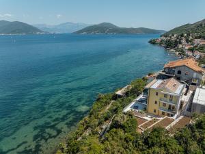 a house on the shore of a large body of water at Njivice Coastal Oasis in Njivice