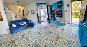 a living room with a blue couch and a tile floor at Luxury Villa Diamante in Casa del Lago +39 photos