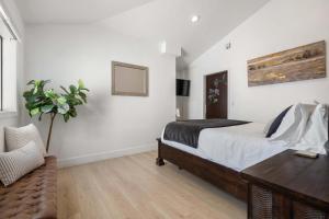 a bedroom with a bed and a table and a chair at Family Pool House with games in National City