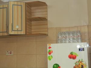 a refrigerator with fruit on it in a kitchen at Beach View Bustani in Kalimoni