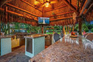 a dining room with a large table in a resort at KonTiki Falls! Jupiter's Exclusive Private Resort in Jupiter