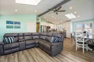 a living room with a leather couch and a kitchen at 2-Min Walk to Beach Large Deck with Outdoor Sofas in Wells