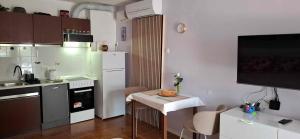 a small kitchen with a small table in a kitchen at Mike1890 in Portorož +5 photos