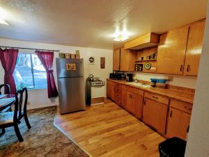 a kitchen with a stainless steel refrigerator and wooden cabinets at Meadow View Cabin in Wilsonia in Wilsonia