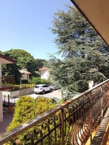 a balcony with a car parked in a parking lot at Villa Angela in Quasani +8 photos