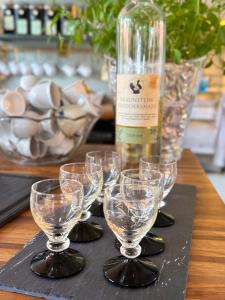 a table with wine glasses and a bottle of wine at Pensionat Næsgaarden in Allinge +37 photos
