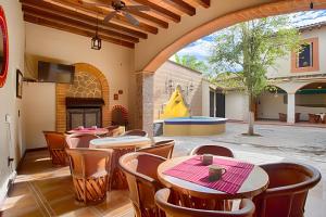a patio with tables and chairs and a pool at Hermosa y amplia casona en Mascota, +16 personas in Mascota