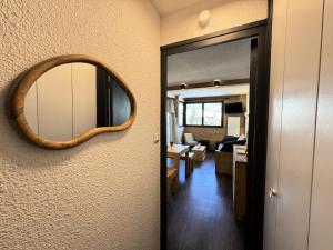 a mirror on the wall of a room with a hallway at Résidence Les Melezes - Studio vue montagne · Accès pistes par navette · Parking extérieur MAE-0944 in Champcella