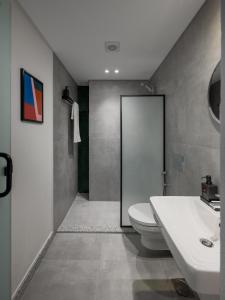 a bathroom with a white toilet and a sink at Livingville East Aparthotel in Cairo