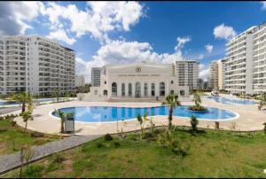 a large swimming pool in front of a building at Caesar Resort Apartments Marcellus 51 in Iskele