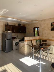a kitchen with a table and a counter top at KOTEJ UREKI in Ureki