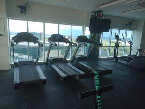 a gym with several tread machines in a building at Flat Particular Marizienne Hotel Saint Moritz 86 in Brasília