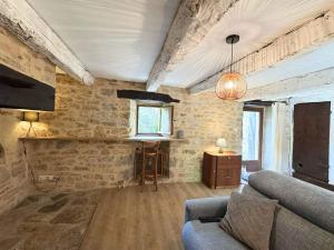 a living room with a couch and a table at La Combe aux étoiles in Villefranche-de-Rouergue