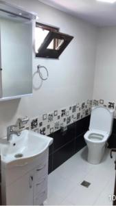 a bathroom with a white toilet and a sink at KOTEJ UREKI in Ureki +18 photos