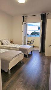 a bedroom with two beds and a view of the ocean at Val Center in Novalja