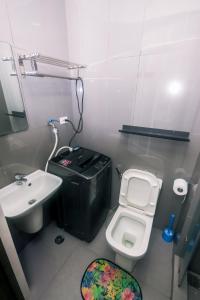 a small bathroom with a sink and a toilet at The Giggle Spot Cozy Makati Hideaway Pool & Gym 2270 in Manila