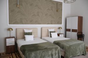 Posteľ alebo postele v izbe v ubytovaní Harmonia Palace