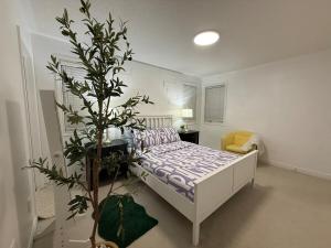 a bedroom with a bed and a tree in it at Luxurious Villa 3 Living Rooms, 1 sofa bed, 4 bedrooms, 4 Beds, 4 Toilets, 1 hour To Toronto in Oshawa +72 photos