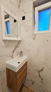 a bathroom with a sink and a mirror at Val Center in Novalja +11 photos