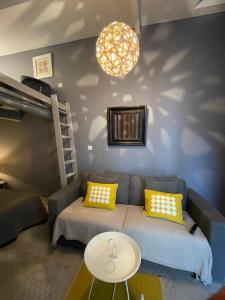 a living room with a couch and a table at Les Terrasses de Thau in Marseillan +23 photos