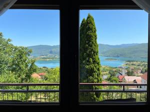 a view of a lake from a window at Apartman Lucija in Rumboci