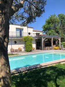 a swimming pool in front of a house at Les Terrasses de Thau in Marseillan