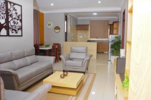 a living room with a couch and a table at White Cottage Suites in Kampala