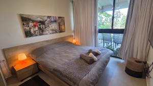a bedroom with a bed with a teddy bear on it at Neot Golf Caesarea Garden Apartment in Caesarea +44 photos