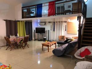 a living room with a loft bed and a dining room at Yangou Appart T4 in Mamoudzou