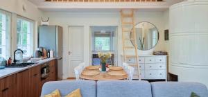 a kitchen with a table and chairs in a kitchen at Meremaa Ateljee in Salinõmme