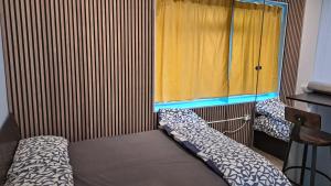 a small room with a bed and a window at Studio Flat in London