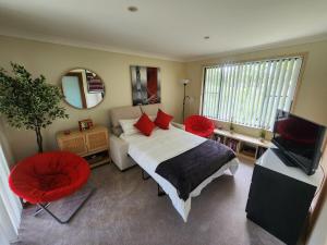 a bedroom with a bed and a television in it at Solitary Islands Golf House in Woolgoolga