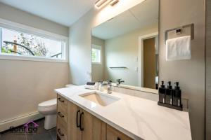 a bathroom with a sink and a mirror at Decked Out, Mtn Views, AC, Big Patio, DT, BBQ in Golden +75 photos