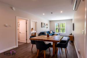 a living room with a wooden table and chairs at Decked Out, Mtn Views, AC, Big Patio, DT, BBQ in Golden