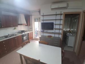 a kitchen with a table and a television in it at Onda Blu in Marina di Vasto