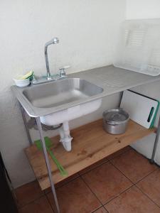 a sink sitting on a shelf under a counter at lindo apartamento in Guatemala +25 photos
