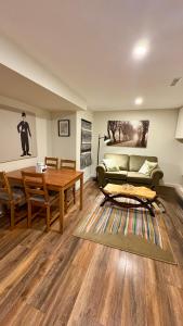 een woonkamer met een bank en een tafel bij Private Apartment Where Remote Work Meets Real Comfort in Oakville