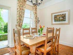 a dining room with a wooden table and chairs at Lynwood in Boscastle
