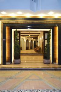a lobby of a hotel with two potted plants at Bright Moon in Dahab +15 photos