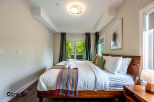 a bedroom with a large bed with a window at Decked Out, Mtn Views, AC, Big Patio, DT, BBQ in Golden