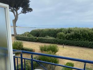 a view of the ocean from a balcony at Appartement 2 personnes - Face plage Valentin - FR-1-843-24 in Le Croisic +2 photos