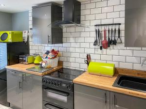 a kitchen with a stove and a green counter top at Jasmin's Retreat in Cleveleys
