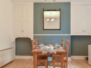 a dining room with a wooden table and chairs at Sunnyside Hestbank in Hest Bank