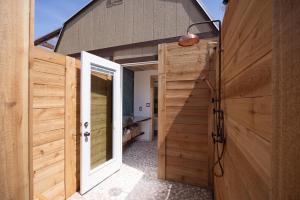 a wooden door leading to a bathroom in a house at Romantic Luxury stay w Sauna, Pool & Amenities on 10 acres in Wimberley